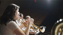 A student playing an instrument