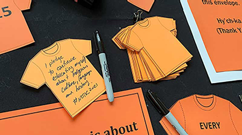 orange shirt paper cutouts with a written message