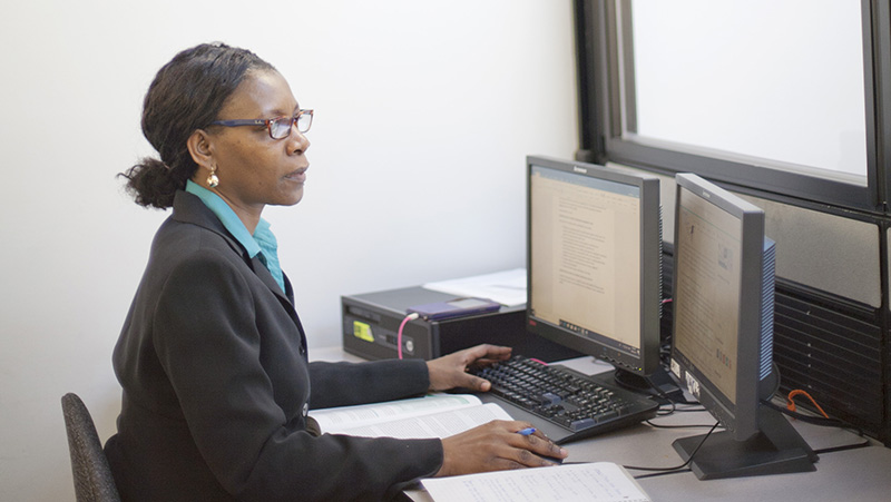 An administrative professional in front of a computer