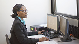 An administrative professional in front of a computer