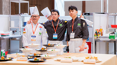 Two alumni and chef Jie Wen