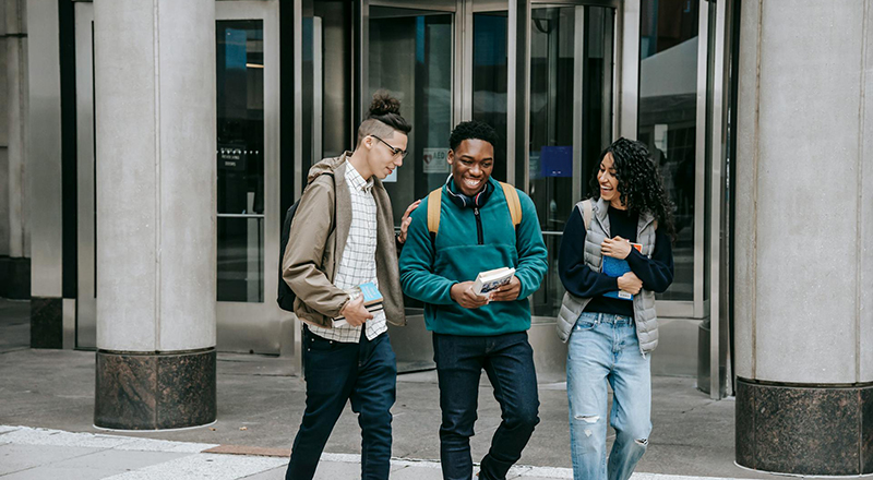 Joyful students in front of school