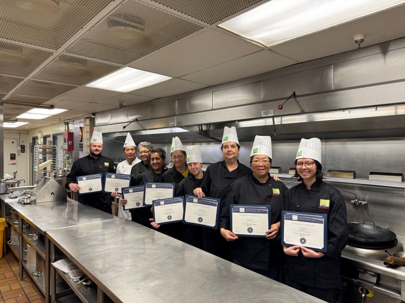 Mount Pleasant Neighbourhood House Culinary students, wearing chef