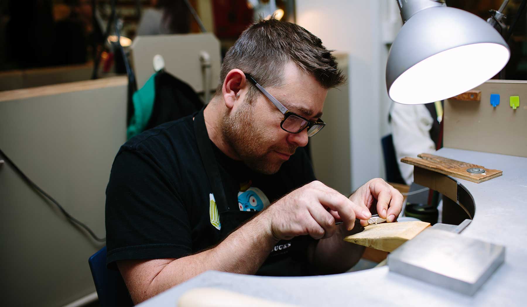 VCC jewellery student polishing a gem