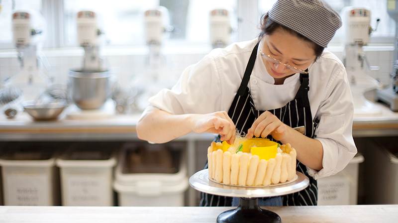 VCC baking student decorating yellow cake