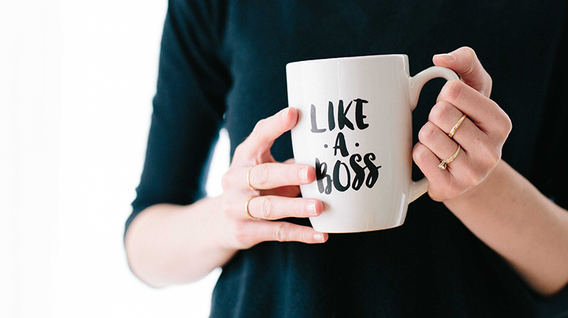 Woman holding coffee mug with text "Like a Boss"