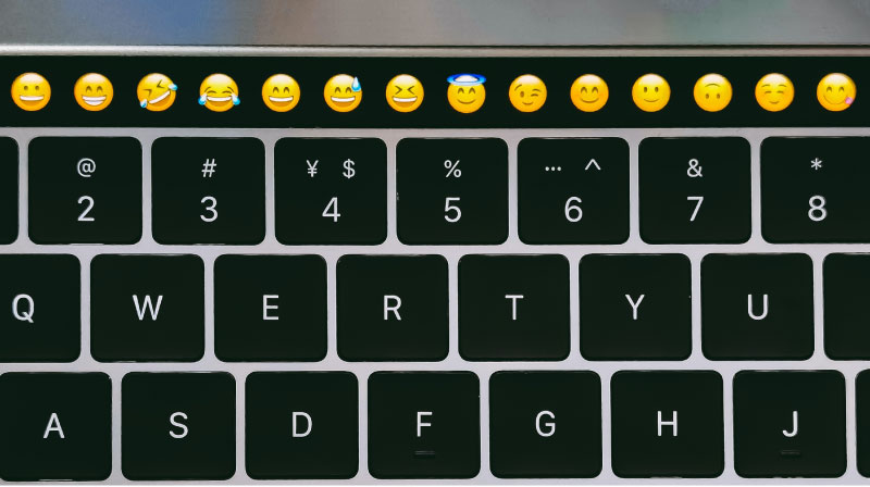laptop keyboard with emojis