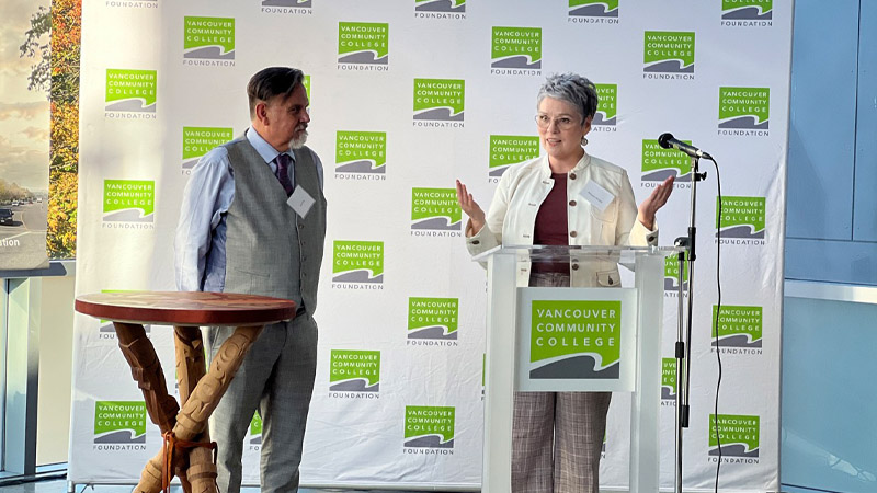 Roxanne Vandale speaking at the students awards ceremony, with Mr. David Kirk, former Dean of Curriculum & Pedagogy, by her side.