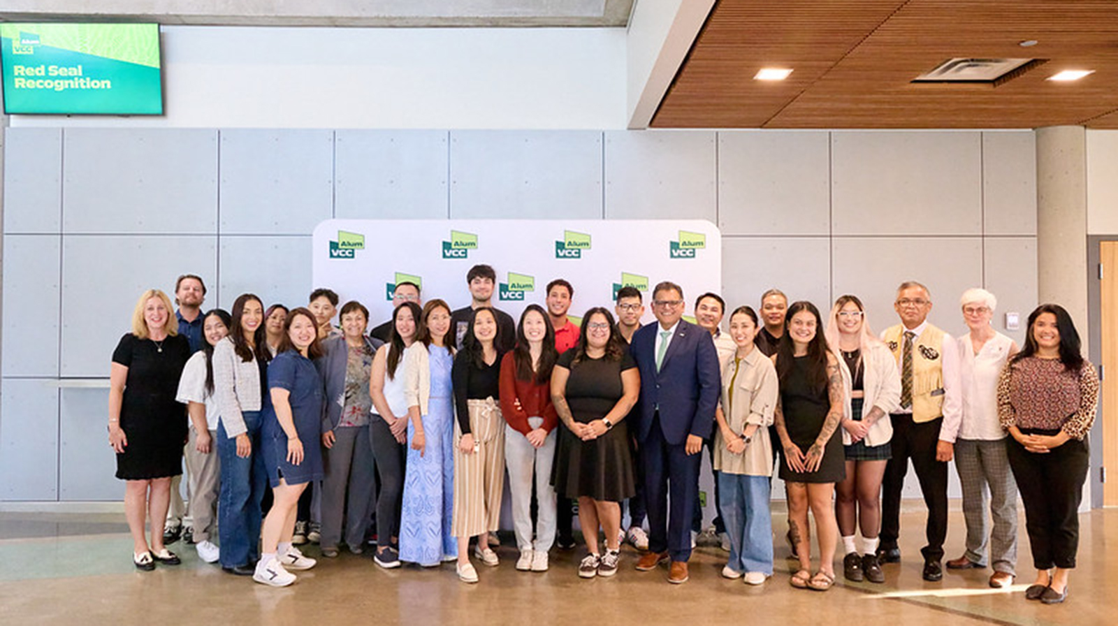 Group of VCC Red Seal students posing in front of backdrop