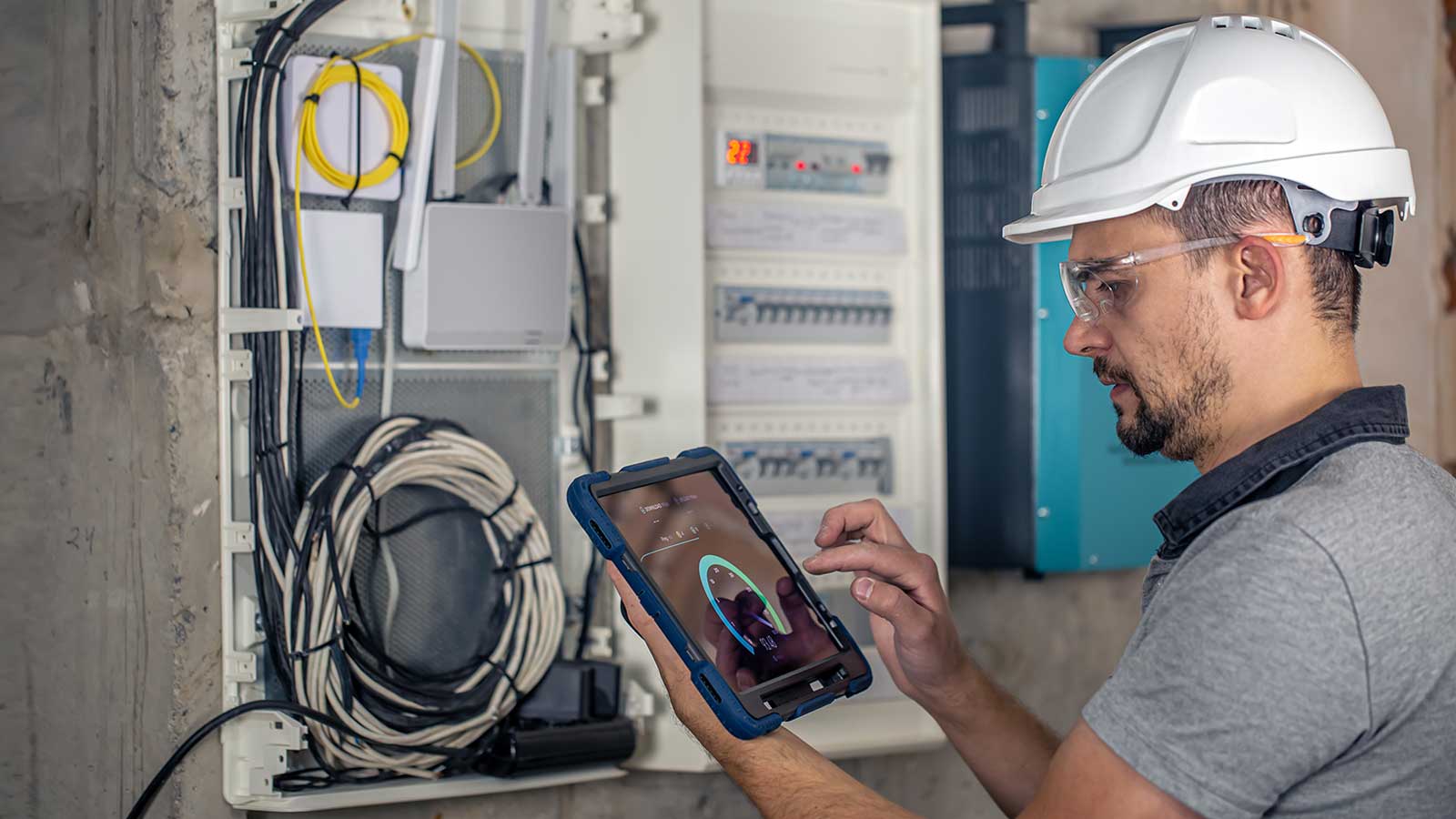 construction electrician working on an electrical panel