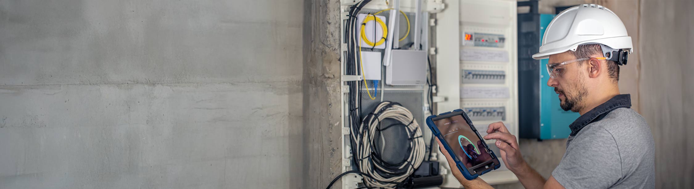 An electrician working on an electrical panel.