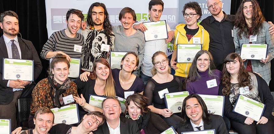 happy students holding their awards