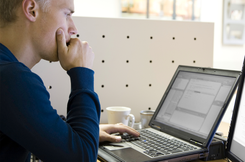 A student is focused on his laptop.