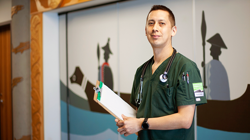 Eddy Gooch in nursing scrubs at VCC’s Indigenous Gathering Space