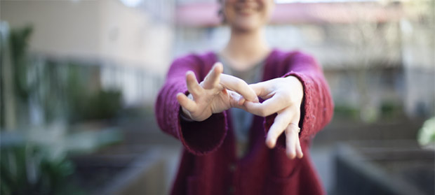 person is demonstrating the American Sign Language (ASL) sign for CONNECT