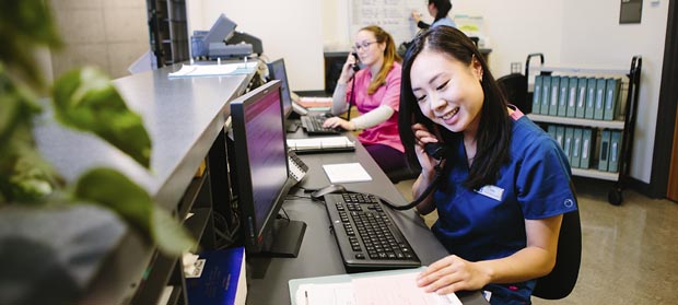 medical office student answering a phone call