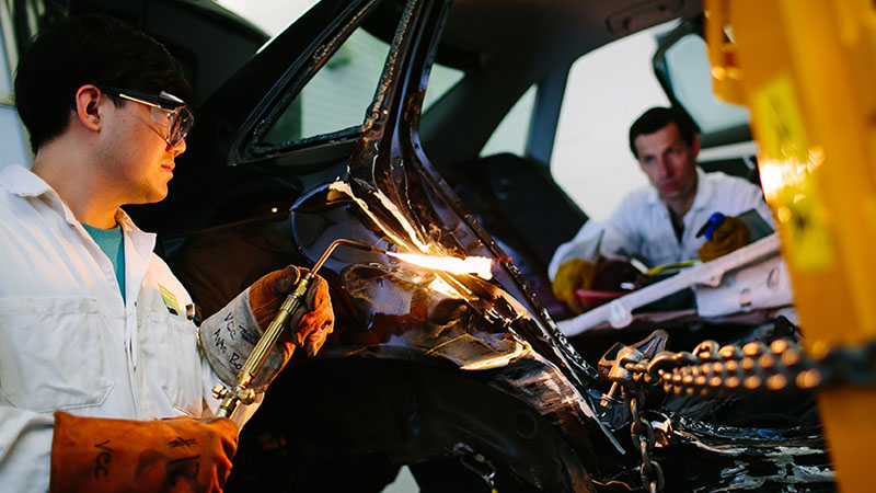 Auto student fixing a car